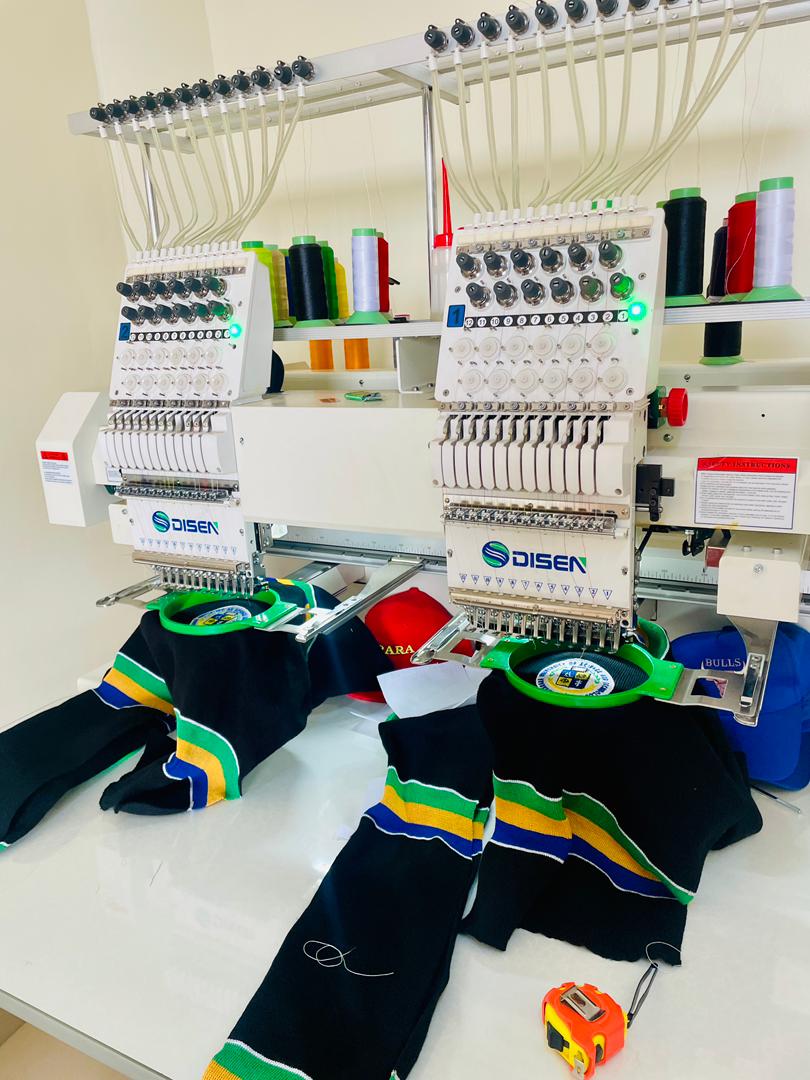Embroidery machine stitching a cap